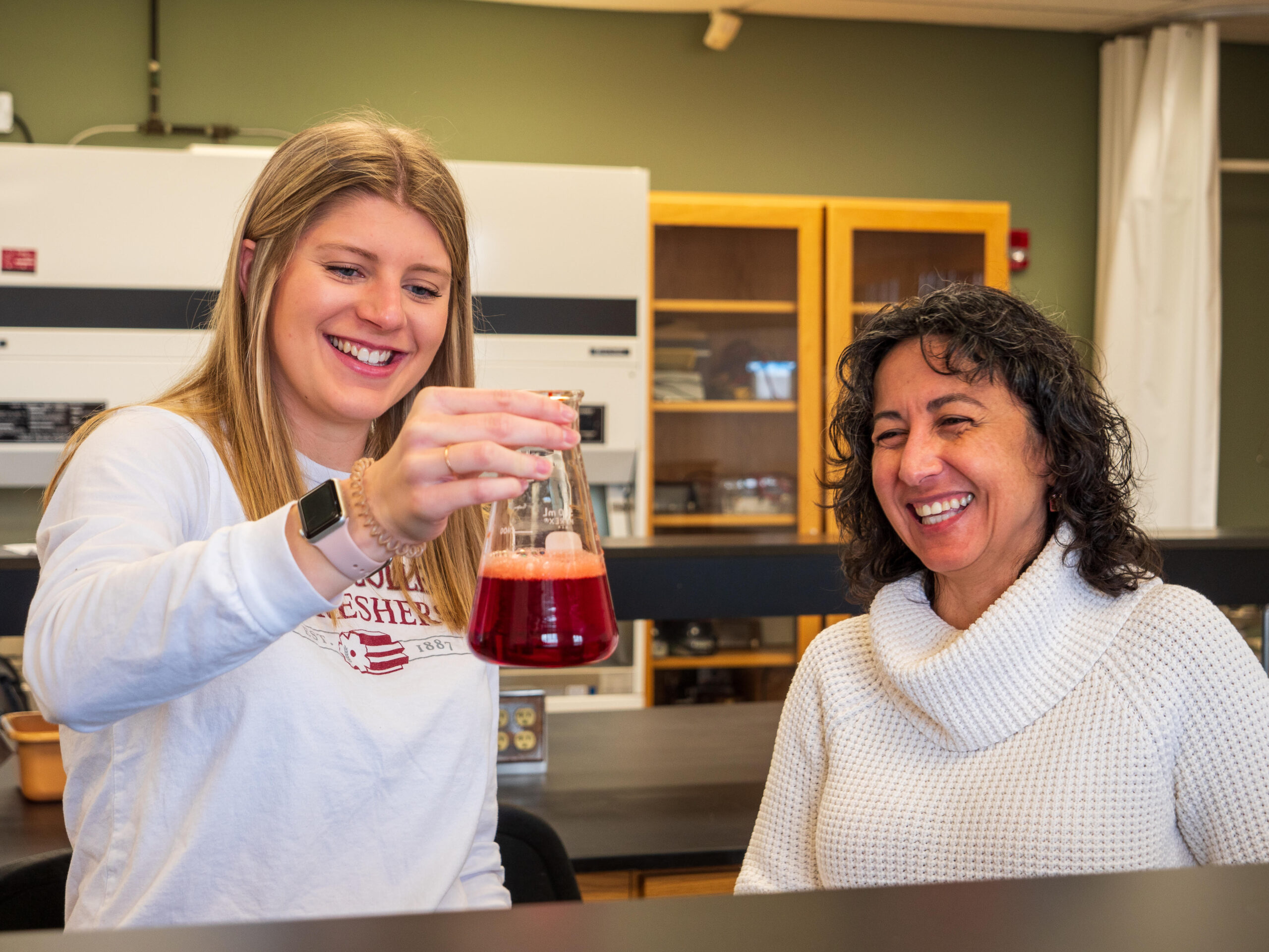 Student and professor in science lab