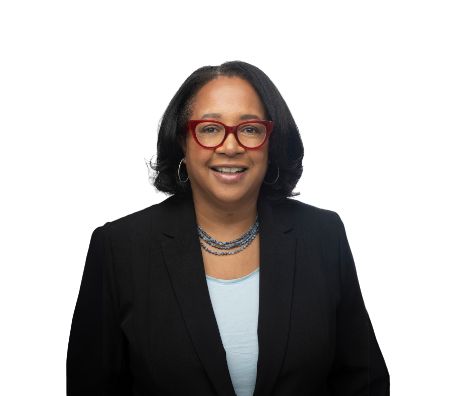 Christina Swarns, in black jacket and white shirt, wearing glasses with red frames