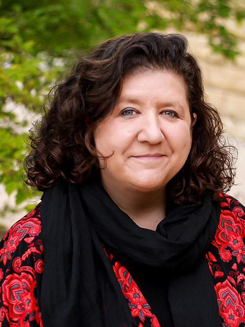 Headshot of Kim Perez in red-and-black shirt with black scarf