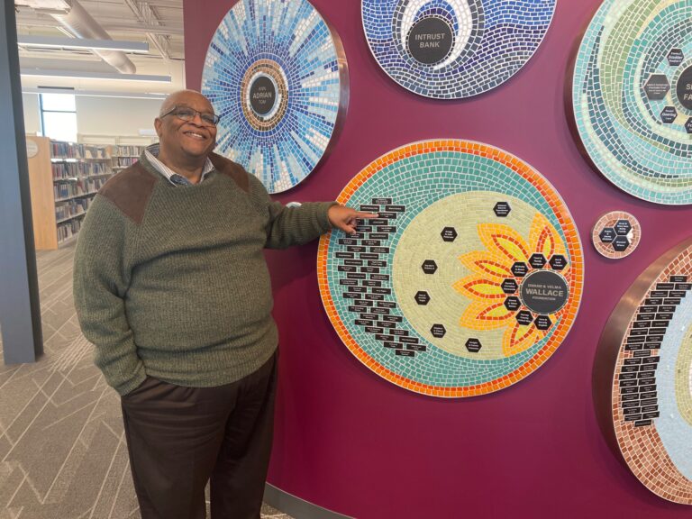 Larry Lee with Newton Public Library mosaic plaques