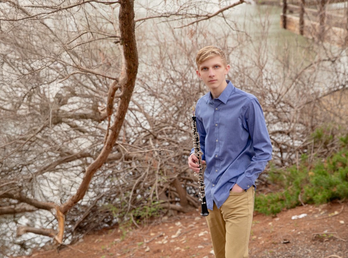 Peter Buller holding his oboe in an outdoor setting