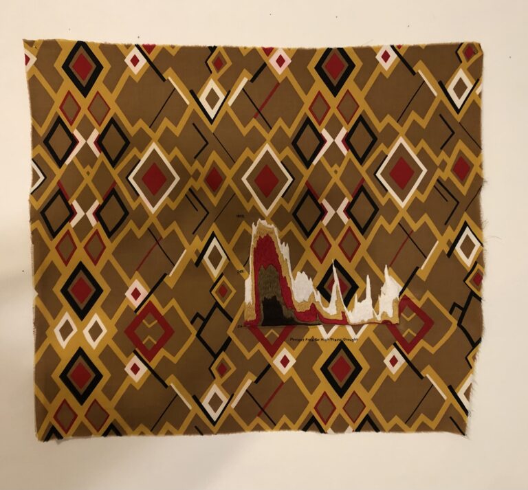 Quilt by Karen Reimer with diamond patterns, in brown, gold, cream, red-orange and black