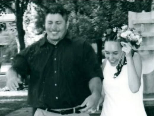 Ben Benavides & Kamara Holsinger getting married in front of the fountain on the plaza between the Ad Building and Fine Arts Center