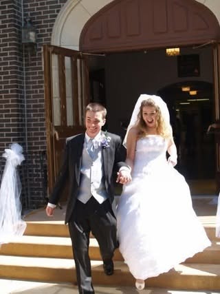 Wedding photo, on steps outside a church, of Marissa Windish & Leslie Branson