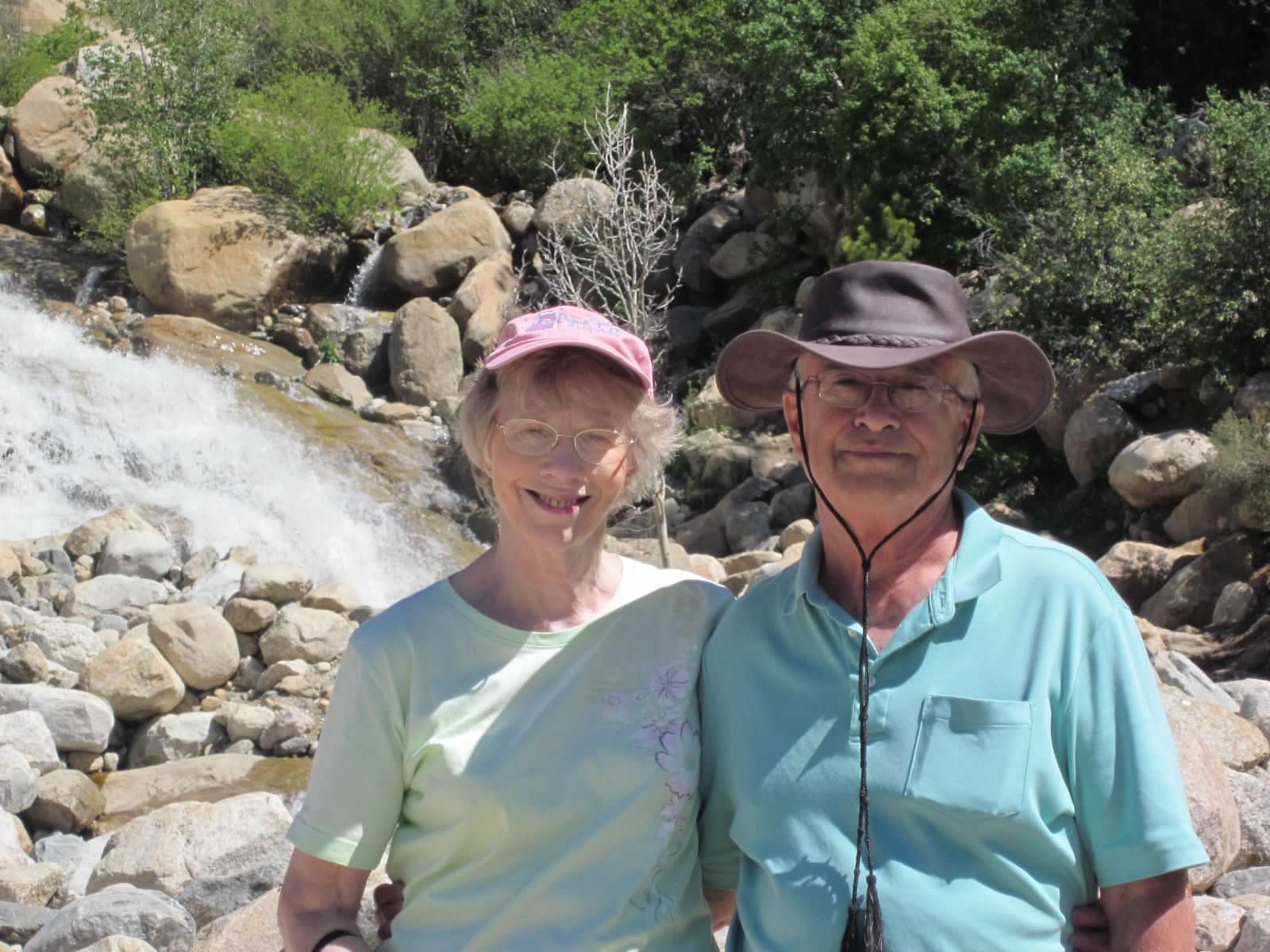 Caryl Smith & Bob Tieszen, outdoors with rocks and trees in background
