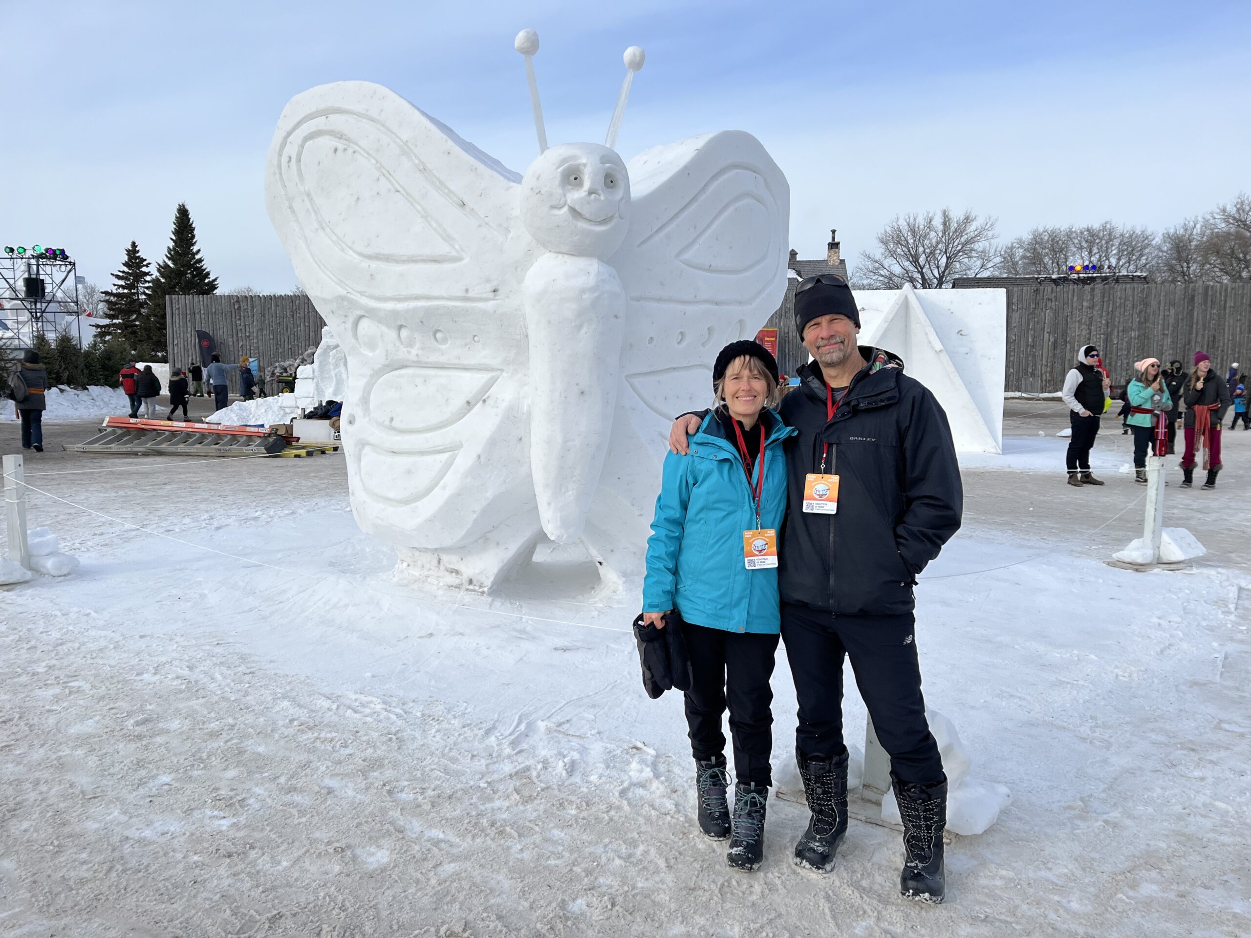 Helen Lepp & Daniel Friesen at a snow sculpting symposium in Winnipeg with a butterfly snow sculpture
